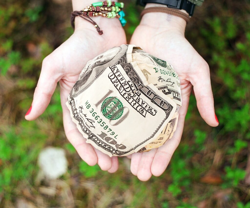 Extra source of income hands showing crumpled dollars
